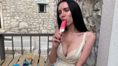 Busty Babe Hungrily Sucking a Popsicle at a Street Cafe